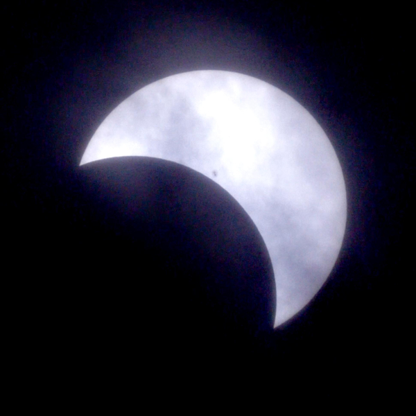 The maximum coverage of the sun. Cloud cover became heavier during the maximum as viewed from Souris.