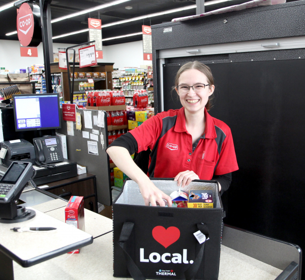 Joy Olsen of the Boundary Co-op grocery store in Boissevain packs a reusable bag.