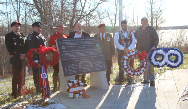 Private Dawson Leforte, Ken McGregor from Canadian Border Services Agency, Terry Lucier from the RCMP, Manitoba Métis Federation (MMF) Minister Will Goodon, MMF Minister Jack Park, MMF Minister Shaun Nault and Turtle Mountain Local Chair Chris Leforte stand proudly by the newly unveiled Métis Veterans Monument at the Turtle Mountain Métis Local at Dromore Lake on November 9. November 8 is now officially recognized as Indigenous Veterans Day in Manitoba. 