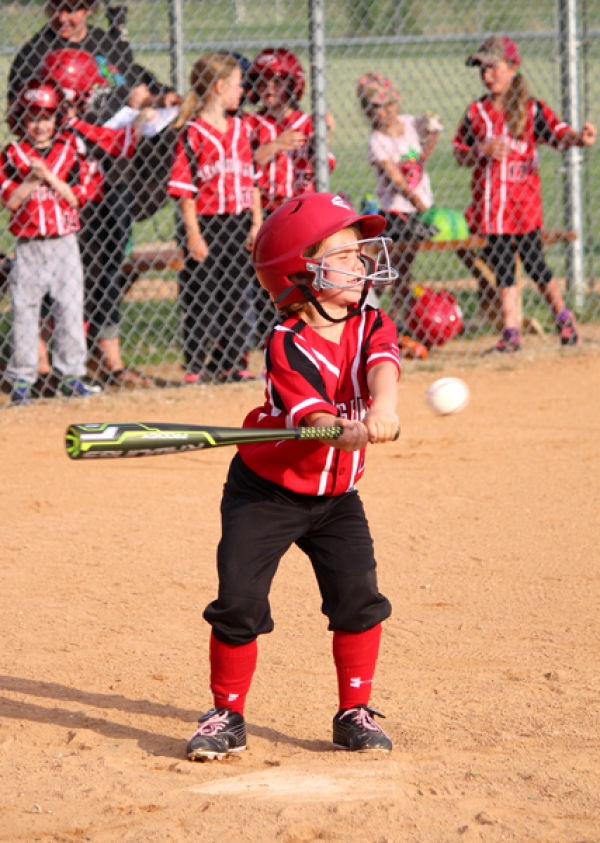 Stella Paschke braces for contact with the ball at the Boissevain 1 vs. Boissevain 2 rookie baseball game on Tuesday, May 29. See more photos inside.     
