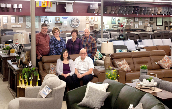 Circle M Furniture new owners, Jamie and Drew Wilkinson (sitting) with previous owners Kevin and Colleen Bridgen (standing on left) 1992-2023, and Sharon and Darwin Slack 1967-1992. 