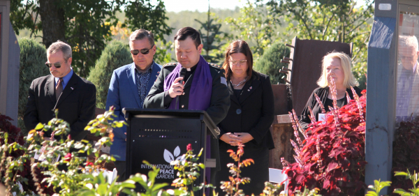 Captain Euikyun Chang, 1 RCHA chaplain at CFB Shilo (front) leads MLA Doyle Piwniuk (left), Premier Heather Stefanson and Peace Garden President Dorothy Dobbie in prayer.