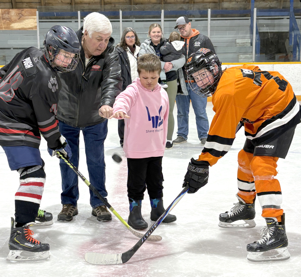 As the Silverwolves celebrated 30 years, organizers honoured the family of Ray Smith Jr., who created their logo and name and who died tragically in a motor vehicle accident. Father Ray Sr. and his grandson William Nestibo drop the puck in a Silverwolves intrasquad game. In the background is Ray Jrs. sister Laurie Nestibo (left) with her daughter Raylin, holding son Raymond, and Zach Klyzub.