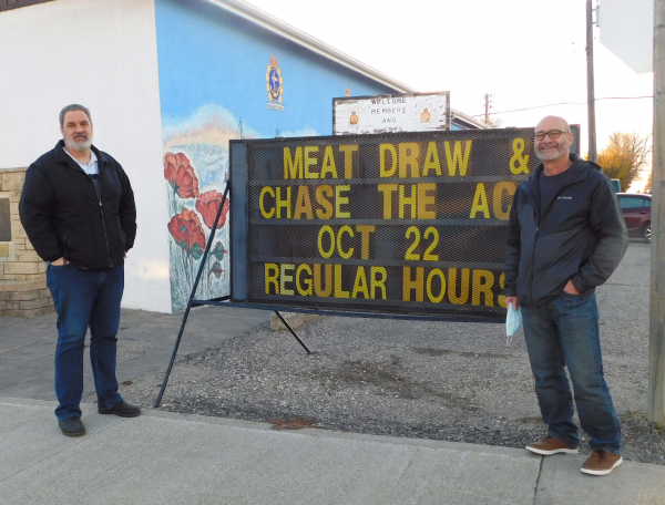 Legion Manager Jason Leigh (left) and Board Member Mark Gillis are happy to announce the re-opening of the Legion in Souris. The meat draw, as the sign says, will start on Friday, October 22.