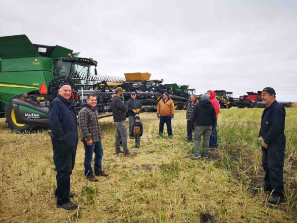 Volunteers prepare to climb into the equipment prior to the harvest at the Boissevain, Morton and Whitewater Growing Project field at Fairfax. The group took only a few hours to complete the work on Thursday, October 1, bringing in a 50.8 bushel per acre crop of canola on 290 acres. This will mean a good return for the Canadian Foodgrains Bank to use for their foreign aid work. They will soon decide what crop they will plant on the field, owned by Del and Heather Fraser, in spring of 2021.