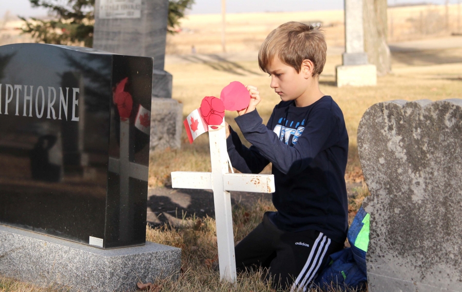 David Martens places a poppy on a veteran’s cross at Boissevain Cemetery. On November 4, Boissevain School students participated in their second No Stone Left Alone program. It was more difficult this year due to COVID, as they could not congregate or have a ceremony with Legion members. Due to the Code Orange, only K-6 students participated in 2020, and each cohort recited On Flanders Fields and placed paper poppies on veteran’s graves.