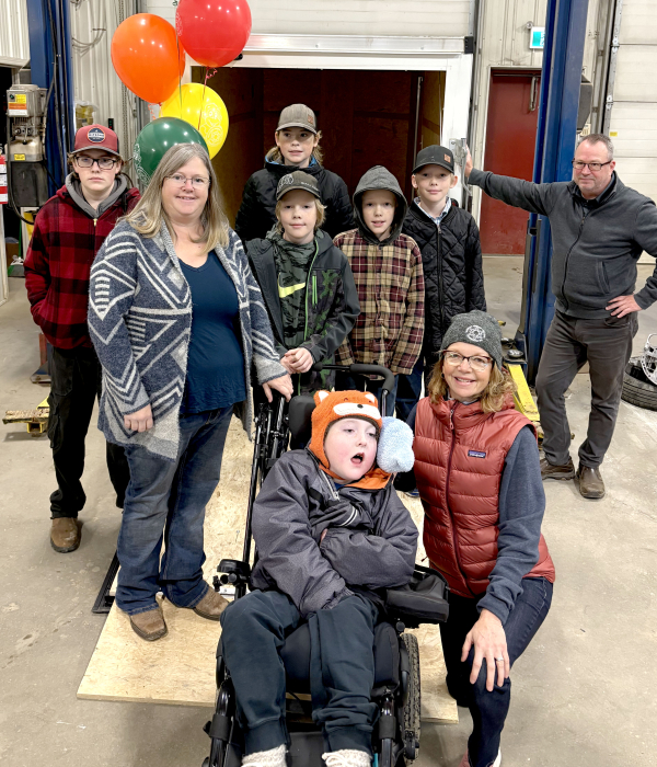 Clay Wilson (front) with Jackie Wells of Westman Dreams for Kids show off Clay’s new trailer with (middle) mother Laura, Layne, Wyatt and Ashton Wilson and Tod Lacey of Advantage Auto + Trailer, and (back) Cole and Shane Wilson. The trailer, organized by Dreams for Kids, helps Clay and family take his special equipment with him wherever he goes allowing greater mobility.