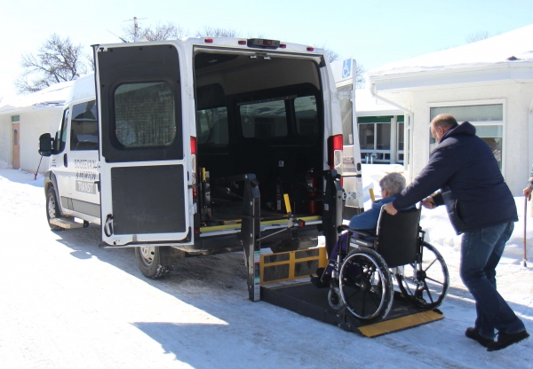 Handi-van casual driver Gib Beard loads a passenger into the small van. With the retirement of Ken Dixon, Boissevain Transit is taking applications for a new full-time driver. The Handi-van is an invaluable tool in helping many people, including seniors, remain active and independent in the community. photo by anna latimer