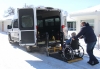 Handi-van casual driver Gib Beard loads a passenger into the small van. With the retirement of Ken Dixon, Boissevain Transit is taking applications for a new full-time driver. The Handi-van is an invaluable tool in helping many people, including seniors, remain active and independent in the community. photo by anna latimer