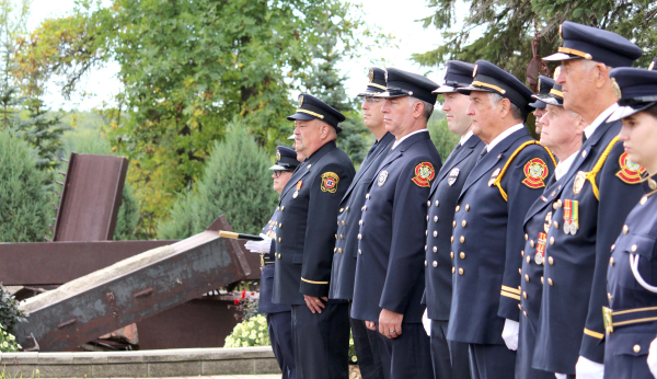 Firefighters honour their fallen at the 9/11 memorial ceremony, held at the International Peace Garden. See story on page 2	
