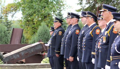 Firefighters honour their fallen at the 9/11 memorial ceremony, held at the International Peace Garden. See story on page 2	
