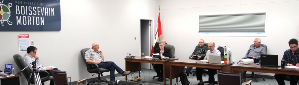 Due to Covid-19 restrictions, it was a small, quiet lagoon hearing on March 25. Only three members of the public joined council in the chambers, although around 20 watched the live stream. (L-R) Councillors Doug Troke, Eric Reichert, Head of Council Judy Swanson, Councillor Rob Adams (back), Councillor David Stead, Consultant Ernie Epp, Councillor George Heide and CAO Leo Poulin discuss the new $9.9 million lagoon proposal for those in attendance and listening through technology.