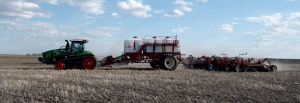 On May 12, the wind was just starting to take its practice runs while Brett and Bill Hodgson of Hodgson Farms worked on sowing beans west of Elgin. In two days time, the area would be hit with horrendous blowing and dust storms. Seeding has progressed fairly well, with warmth and moisture needed.	 
