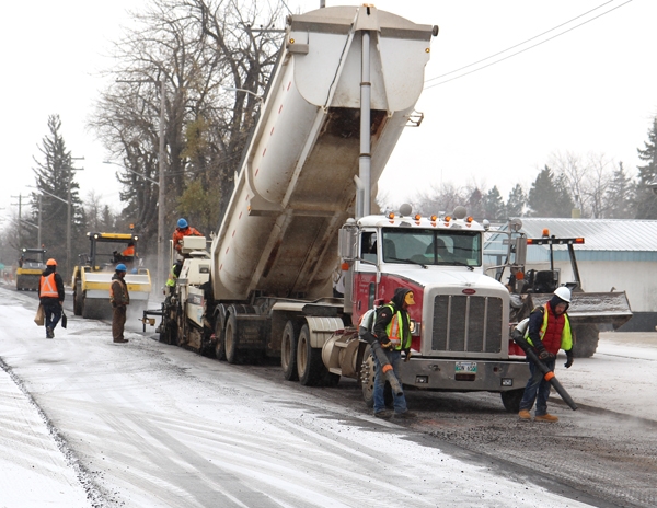 Contractors rushed to finish laying asphalt on Wednesday, November 1 as the snow fell around them all day. Leaf blowers were used to remove fresh snow from the road while asphalt was being laid. The project is about 80% complete, and will be staying that way until spring.      