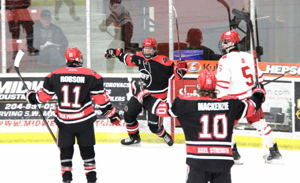 Although the Southwest Cougars fell a little short in the Telus Cup finals, they made it a game, starting with this Brett Laing goal at the end of the second period. The Boissevain defenseman celebrated with forward Nate Robson of Carberry (11) and forward Luke Mackenzie (10) of Pipestone.