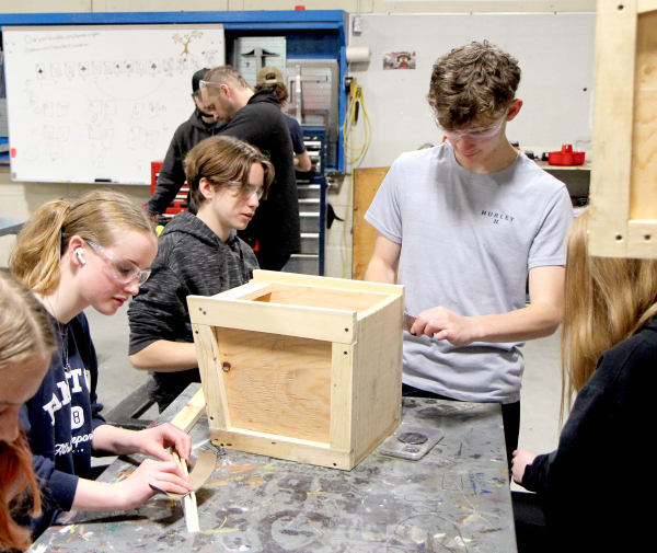 Abby Halloran, Gary Nowazek and Russell Harper work on construction of the story boxes for the International Peace Garden. The grade 9/10 metalworking class at Boissevain School is building 10 boxes to hold books for the different flower beds at the International Peace Garden.
