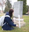 Kenzie Canada, of Boissevain School, puts a fresh coat of white paint on a veteran’s cross at a grave at Boissevain Cemetery. Some advisory groups from the school went out to honour and remember veterans by cleaning up their crosses on October 28. 