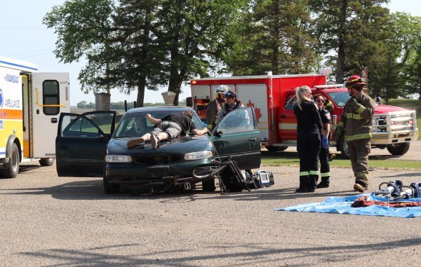 On Wednesday morning, Mothers Against Drunk Driving (MADD) held a mock car accident to raise awareness for the victims of impaired driving. Bike rider “victim” Grey Stewart was “struck” by driver Daniel Godin. RCMP, EMS, Fire Department, and even a hearse were all on-scene at Boissevain School on June 4.